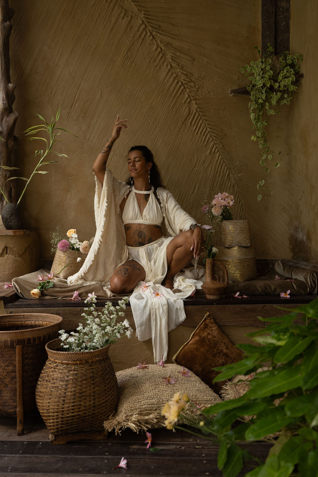 A model dressed in the Inika Set, standing gracefully in a rustic, nature-inspired interior, surrounded by pampas grass and woven textures. This sheer bohemian skirt and top combination is perfect for ethereal elegance. From Bird of Paradise, handmade sustainable fashion.