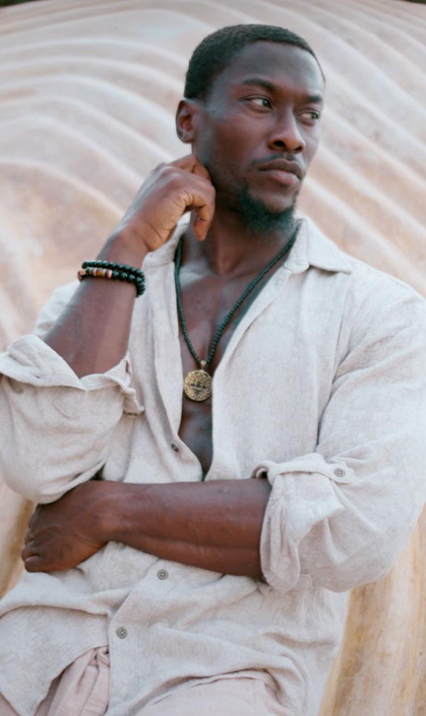 Man wearing the Kairos Shirt from Bird of Paradise, a lightweight cotton shirt with a subtle floral pattern. This bohemian-inspired, slow fashion piece embodies Bali boho clothing and designer sustainable fashion.