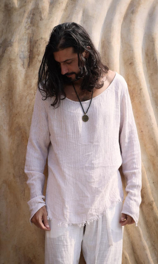 Man wearing the Zahir Shirt from Bird of Paradise, a bohemian long-sleeve shirt crafted from natural cotton. This ethically made piece reflects slow fashion in Bali, offering breathable comfort and timeless elegance.