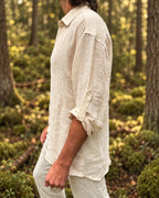 Side view of the Angin shirt with the sleeve rolled to the elbow