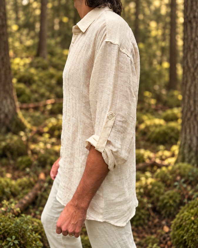 Side view of the Angin shirt with the sleeve rolled to the elbow