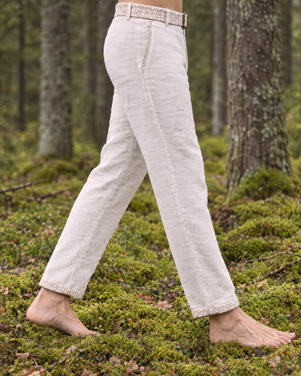 Side view of the Kairos linen trousers worn with the matching embroidered belt