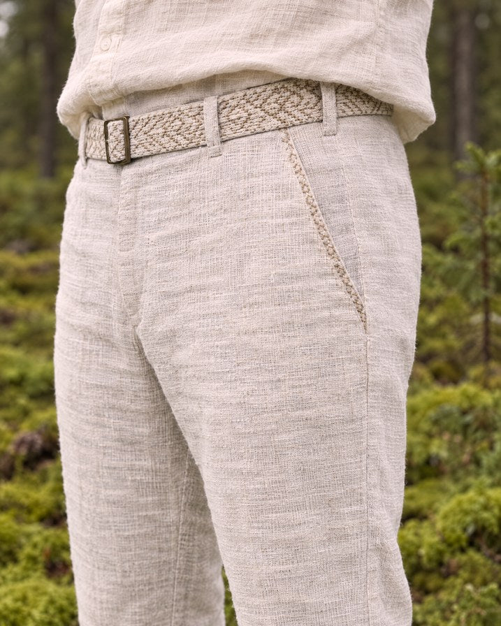 Detail of the embroidered belt and hand-stitched pocket trim on the Kairos Pants