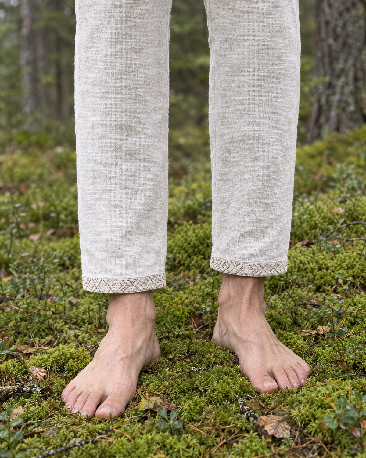 Hand-embroidered band at the hem of the Kairos linen trousers