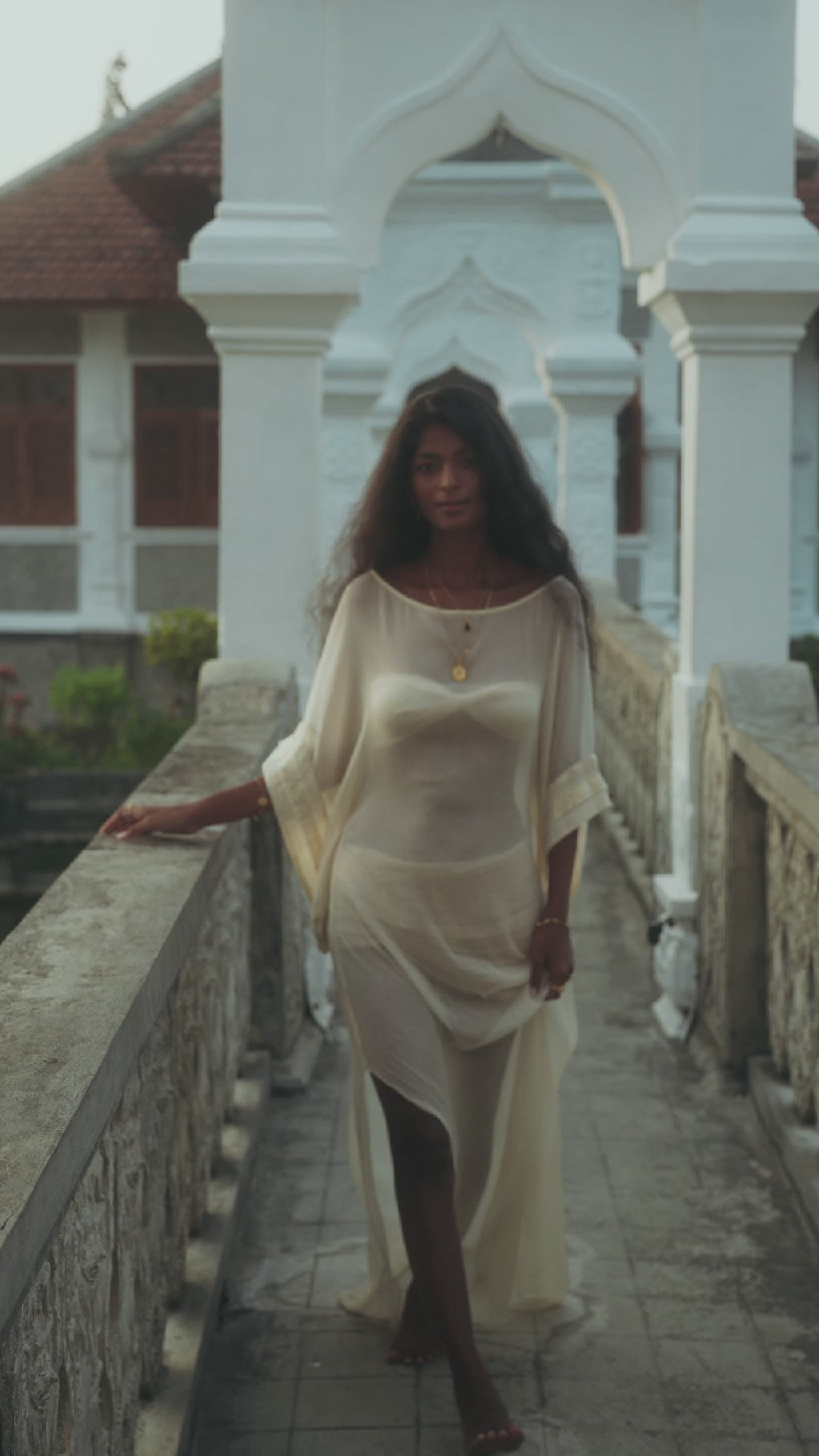 Woman wearing a sheer, flowing Sundari Kaftan in natural silk chiffon, embodying effortless bohemian elegance. This handmade sustainable fashion piece is perfect for Bali boho clothing lovers and slow fashion enthusiasts