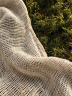 Close-up of the open handloom linen gauze of the Serat shirt