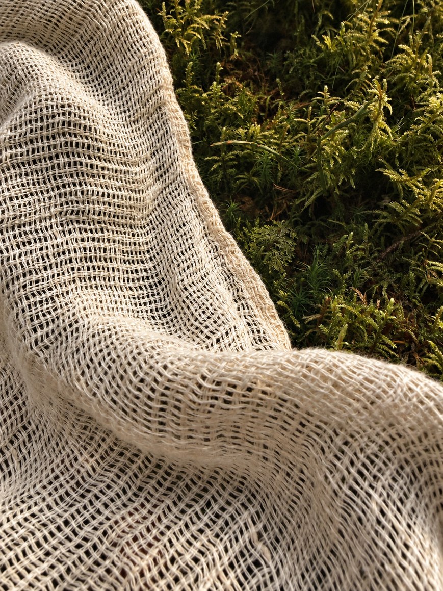 Close-up of the open handloom linen gauze of the Serat shirt