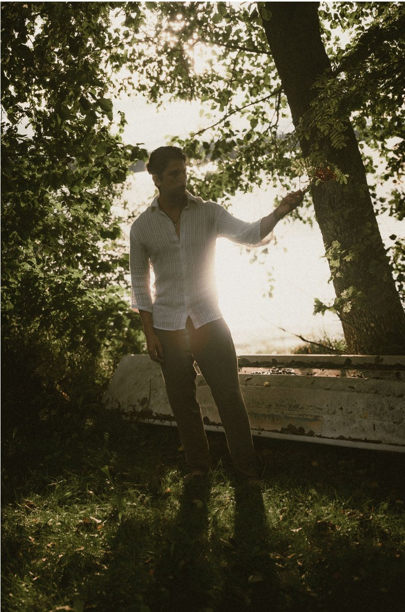 Udara shirt worn by a lakeside at golden hour